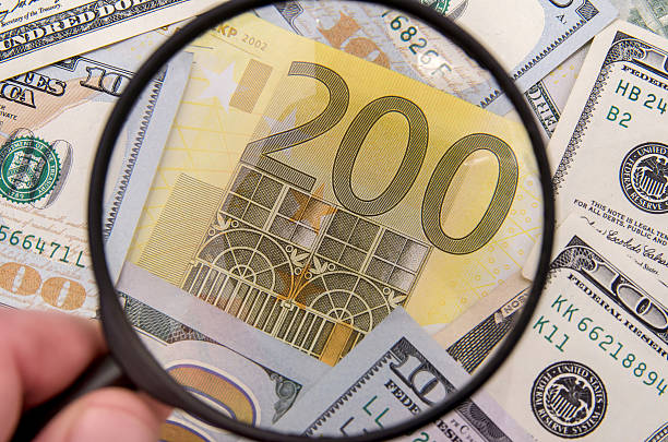 istock Magnifying glass over 200 euro notes. US dollar as background 500671766