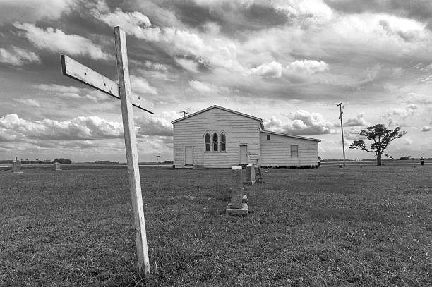 Rest in peace in the delta Small graveyard behind clapboard church in the Mississippi delta mississippi delta stock pictures, royalty-free photos & images