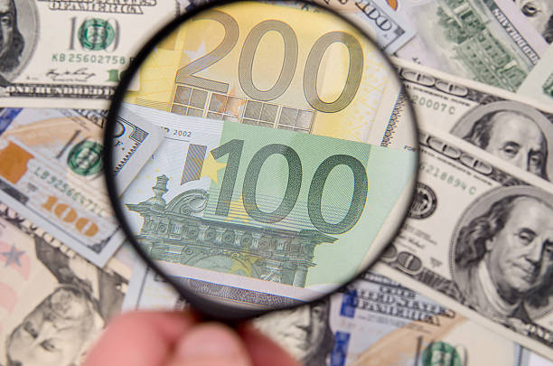 istock Magnifying glass over 200 euro notes. US dollar as background 500671884