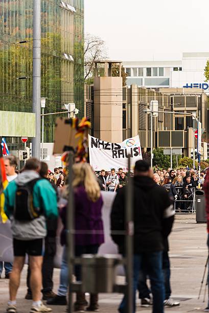 Counterdemonstration against radicals of the right wing Heidelberg, Germany - October 24, 2015: Counterdemonstration against radicals of the right wing 'Steh auf für Deutschland' in Heidelberg. More than 900 people demonstrated against the 40 hooligans. national democratic party of germany stock pictures, royalty-free photos & images