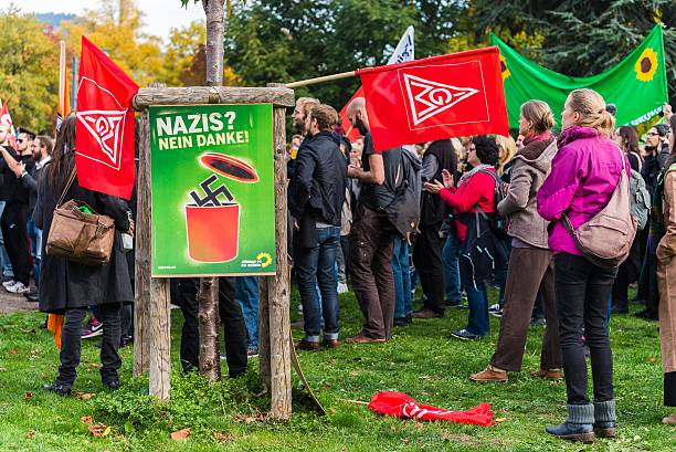 Counterdemonstration against radicals of the right wing Heidelberg, Germany - October 24, 2015: Counterdemonstration against radicals of the right wing 'Steh auf für Deutschland' in Heidelberg. More than 900 people demonstrated against the 40 hooligans. national democratic party of germany stock pictures, royalty-free photos & images