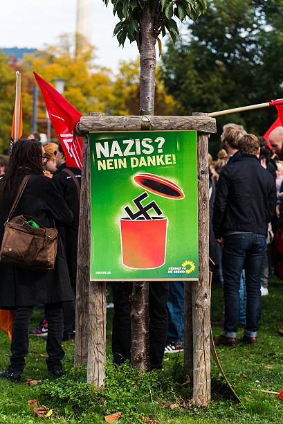 Counterdemonstration against radicals of the right wing Heidelberg, Germany - October 24, 2015: Counterdemonstration against radicals of the right wing 'Steh auf für Deutschland' in Heidelberg. More than 900 people demonstrated against the 40 hooligans. national democratic party of germany stock pictures, royalty-free photos & images