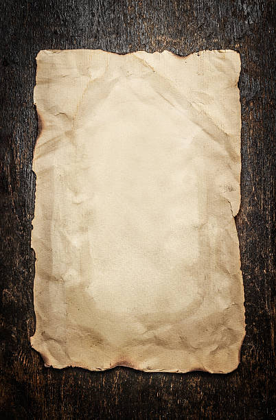 istock Old paper on a aged wooden background, frame 500672624