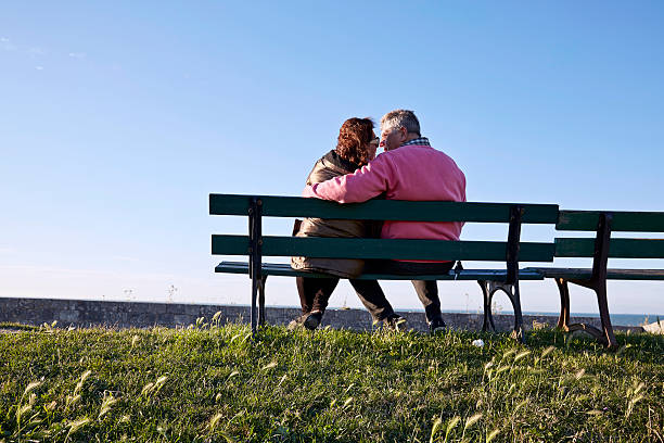 istock Senior couple on  bench at harbour sunset 500672786