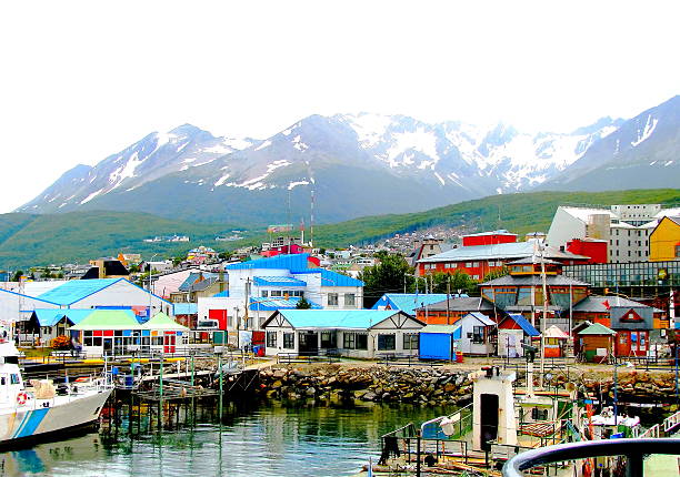 Colorful houses at the end of the world Multi colored houses in the Patagonian city of Ushuaia, Argentina. Ushuaia is the capital of the Argentine province of Tierra del Fuego. It is commonly regarded as the southernmost city in the world. Ushuaia is located in a wide bay on the southern coast of the island of Tierra del Fuego, bounded on the north by the Martial mountain range and on the south by the Beagle Channel. It is also the setting off port for many Antarctic cruises.       beagle channel stock pictures, royalty-free photos & images