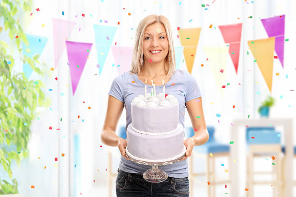 istock Cheerful woman holding a birthday cake 500677922