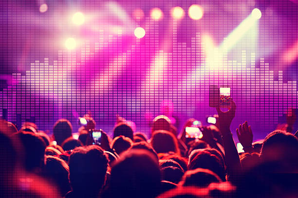 istock Young people dancing at music concert with sound wave 500678516
