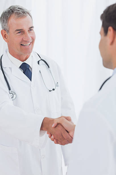 istock Experienced doctor welcoming his new coworker 500683417
