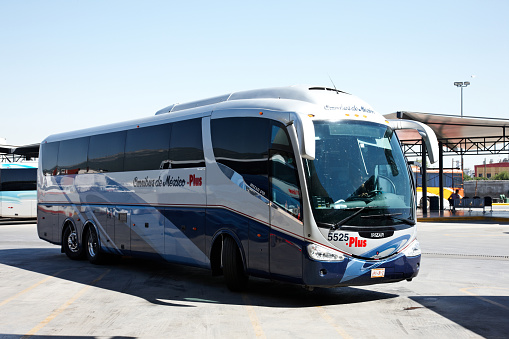 Monterrey, Mexico - May 15, 2014: Mexican luxury coach at Monterrey bus terminal. Passengers and driver are pictured through the windows