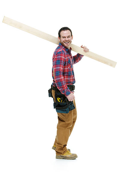 istock Side view of carpenter standing with plank 500684649