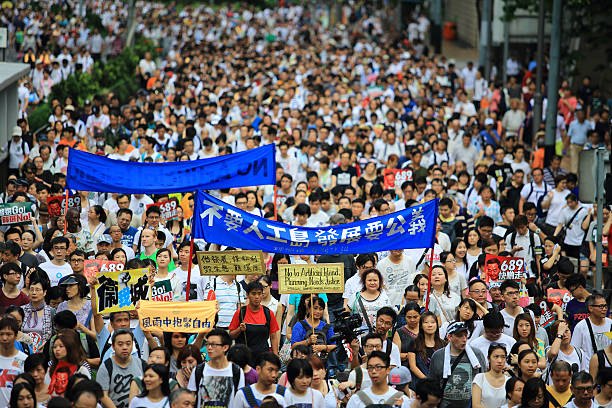 Hong Kong, Сhina - July 1, 2014: People protest on the street in hong kong in July 1. People protest for urban development, housing issue, and mainland china policy to hong kong,