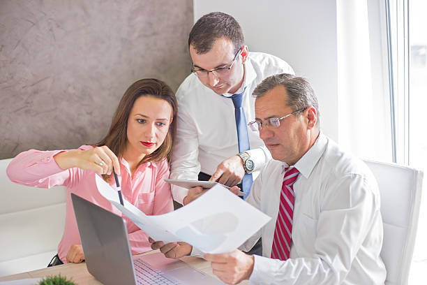 istock Workers at office meeting standing to see reports 500692162