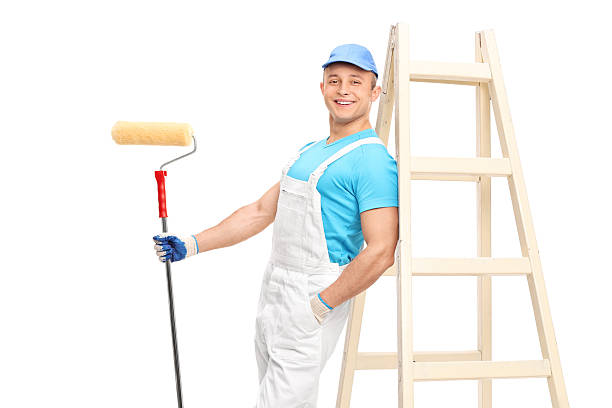 istock Young male decorator holding a paint roller 500693240
