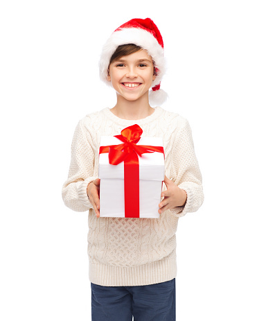 holidays, presents, christmas, childhood and people concept - smiling happy boy in santa hat with gift box