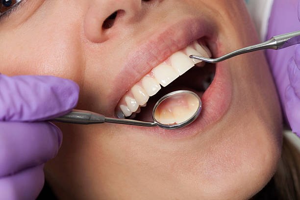 istock Dentist working on girls teeth 500694548