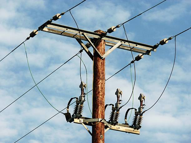 telegraph pole wooden blue sky fluffy clouds