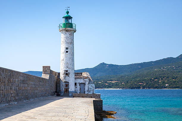 istock White stone lighthouse tower on the pier 500695458