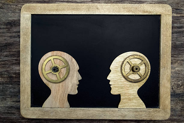istock Two human head silhouettes with gears 500696196