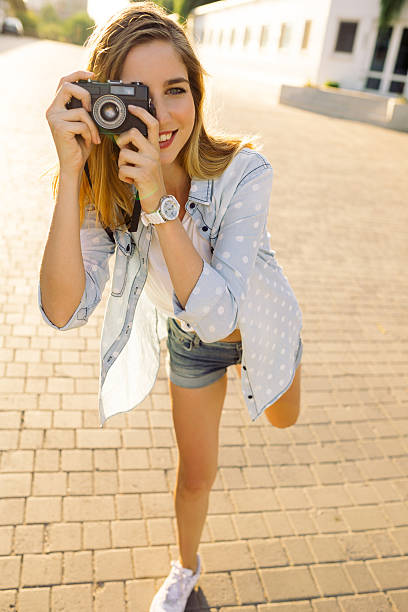 istock Hipster woman with retro film camera 500699730