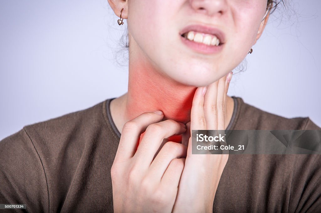 Little girl with sore throat  touching her neck Little girl with sore throat  touching her neck.Sore throat sick.Little girl having pain in her throat. Adult Stock Photo