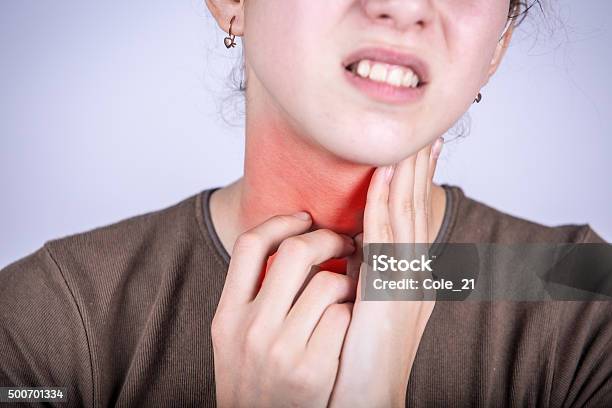 Little Girl With Sore Throat Touching Her Neck Stock Photo - Download Image Now - Adult, Allergy, Boys