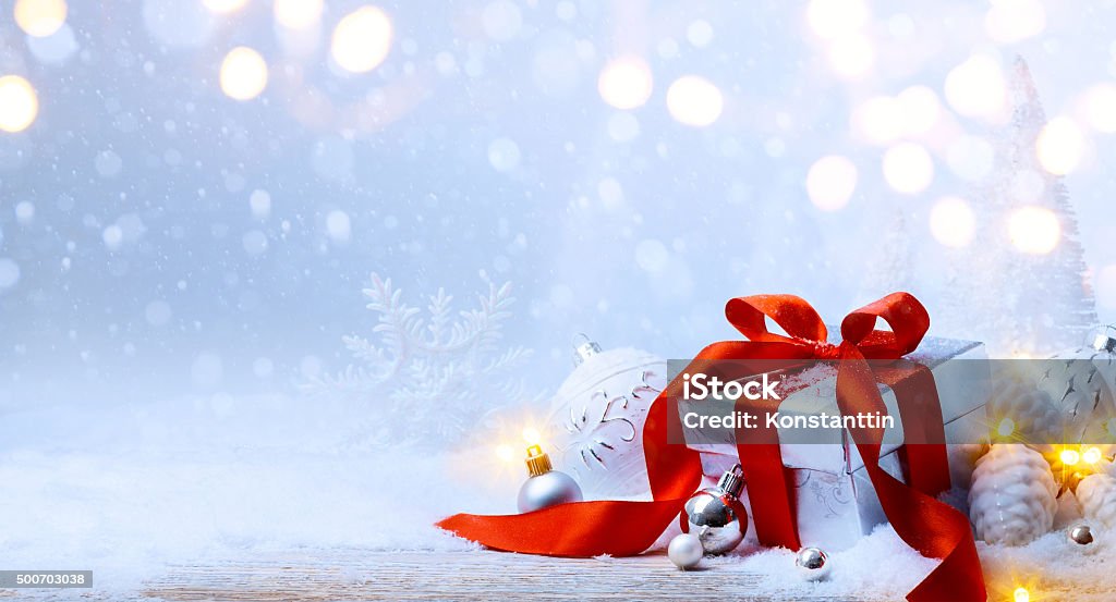 art Christmas balls and gift box on snow Christmas tree light; festive background with Christmas balls and gift box on snow Bag Stock Photo