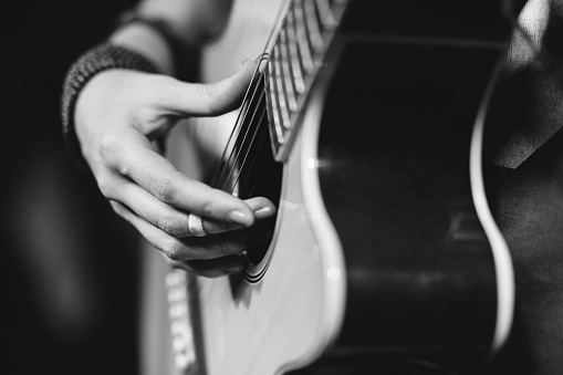 istock Close up of girl playing a guitar 500703058