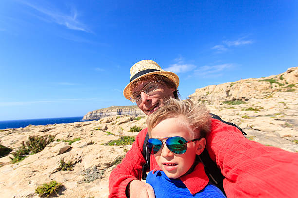 istock father and son taking selfie while hinking in mountains 500703794