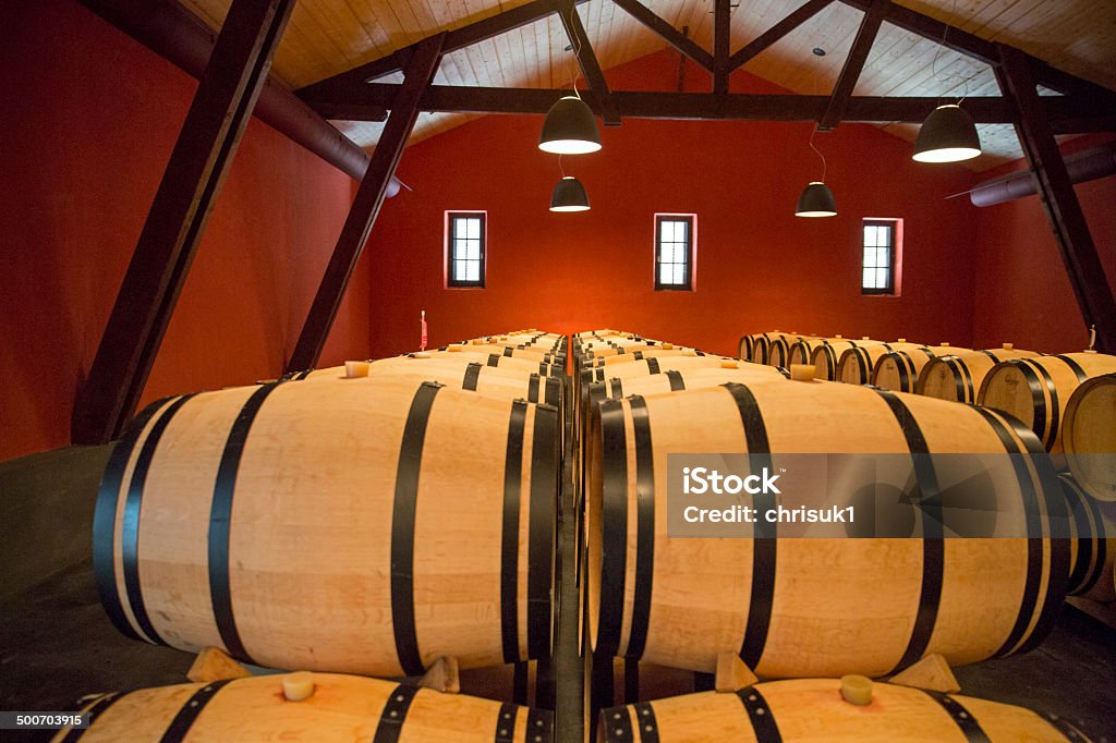 Oak Barrels in Vineyard store - Bordeaux, France These traditional oak wood barrels are storing a French Bordeaux Red Wine Castle Stock Photo