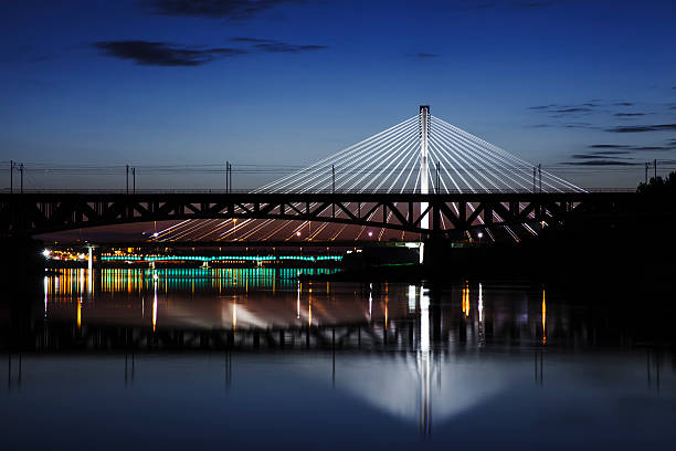 istock Highlighted bridge at night and reflected in the water 500704215
