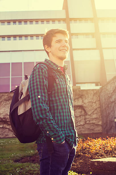 istock University.Smiling young student man on a university background 500704268