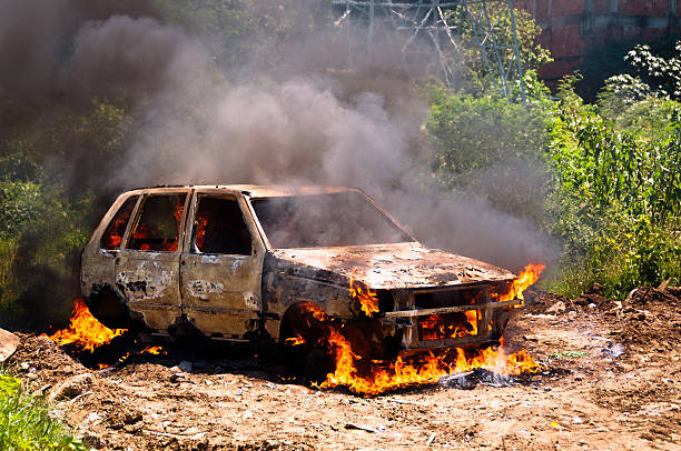 istock Burning Car in the Field 500705223
