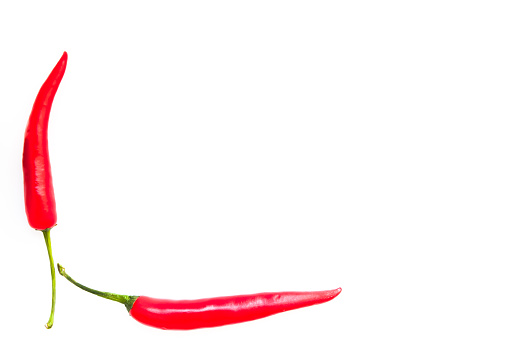 Two spicy bright red hot chili pepper on white background