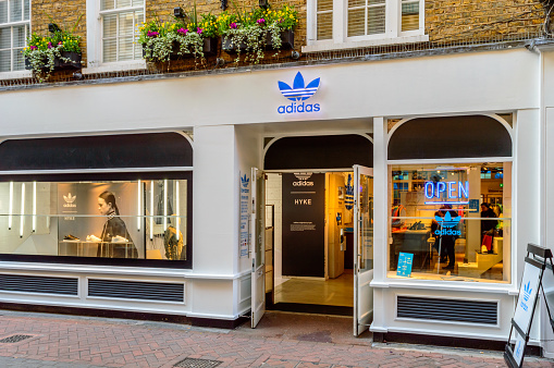 London, England - October 26, 2015: The shop front of Adidas Originals store. Store is open, with some customers inside. On Foubert's Place, off Carnaby Street.
