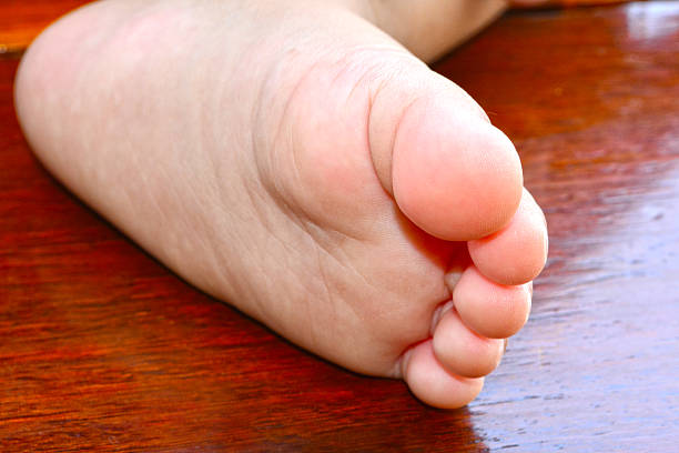istock Baby foot on wooden background. 500706551