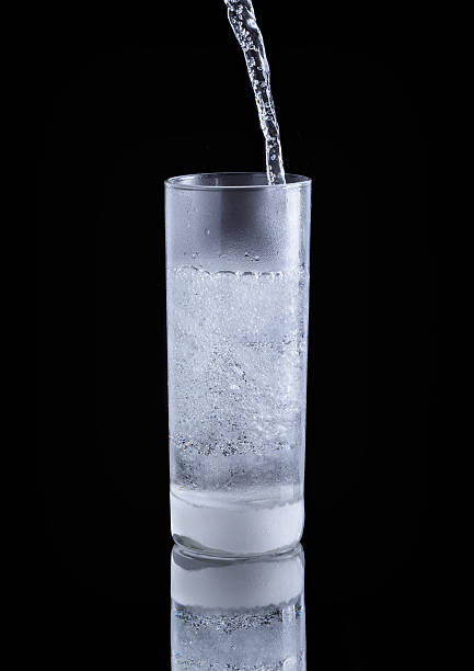 istock pouring cold water in simple highball glass 500707663