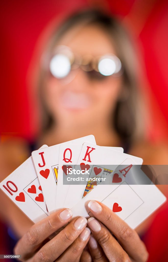 Poker hand Woman holding a poker hand at the casino Adult Stock Photo