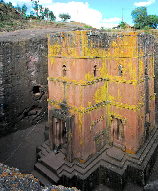 Lalibela, Ethiopia: rock-hewn Church of Saint George Lalibela, Amhara region, Ethiopia: rock-hewn Church of Saint George / Biete Giyorgis - carved from red volcanic rock in the shape of a cross - 12th century - the most famous of the eleven monolithic churches in Lalibela - Ethiopian Orthodox Tewahedo Church - UNESCO world heritage site - photo by M.Torres the church of saint george lalibela ethiopia stock pictures, royalty-free photos & images