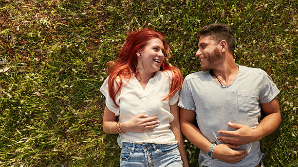 istock Happy young couple lying on the grass 500722456