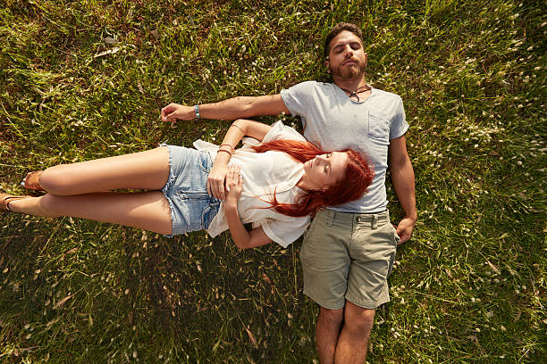 istock Young couple resting together on the grass. 500722530