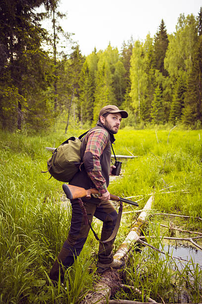 istock Animal Hunter Crossing a Swamp 500723088