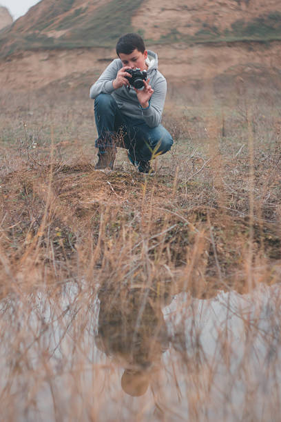 istock Young boy shooting with vintage camera 500724838