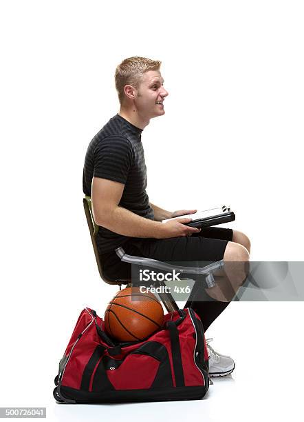 Side View Of Young College Student Sitting Stock Photo - Download Image Now - Carrying, Duffel Bag, Men