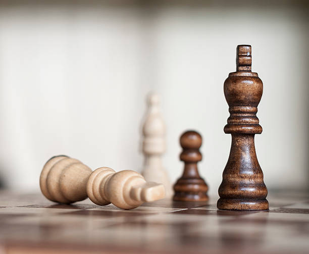 istock Wooden Chess Figures With The White King Surrendering 500727236