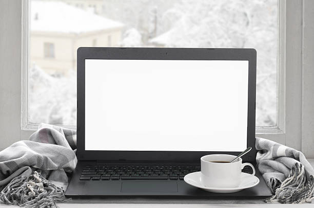 Laptop on winter window stock photo