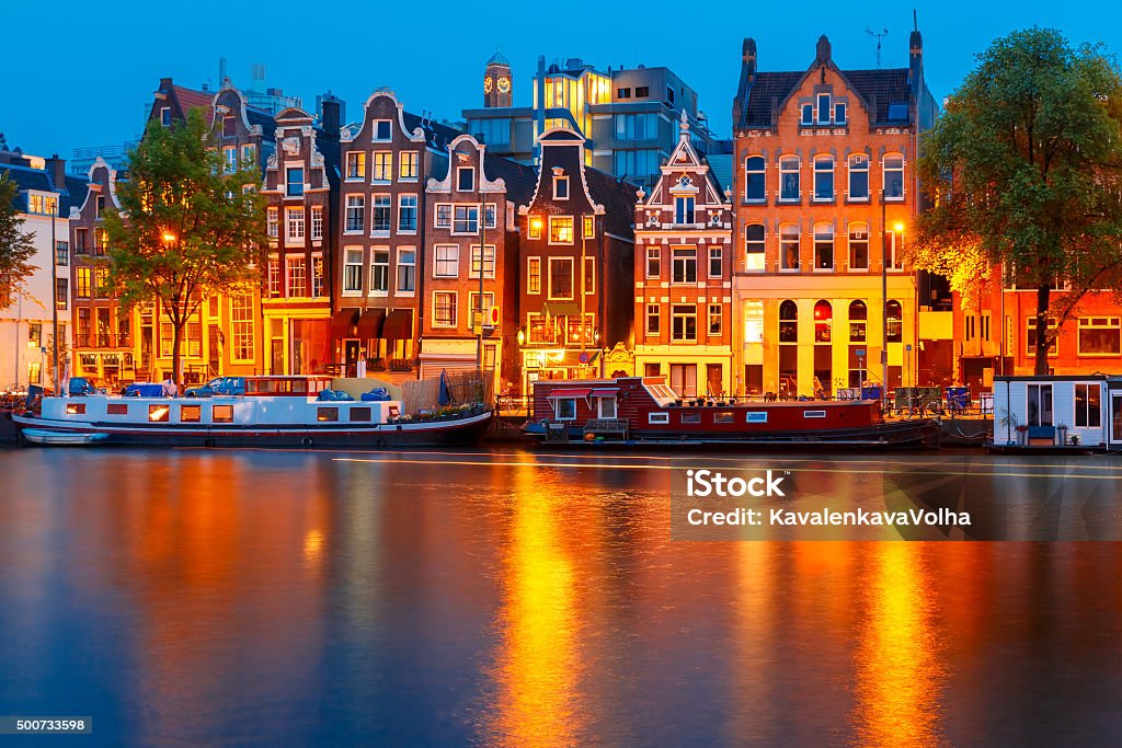 Night city view of Amsterdam canal Night city view of Amsterdam canal, typical dutch houses and boats, Holland, Netherlands. Amsterdam Stock Photo