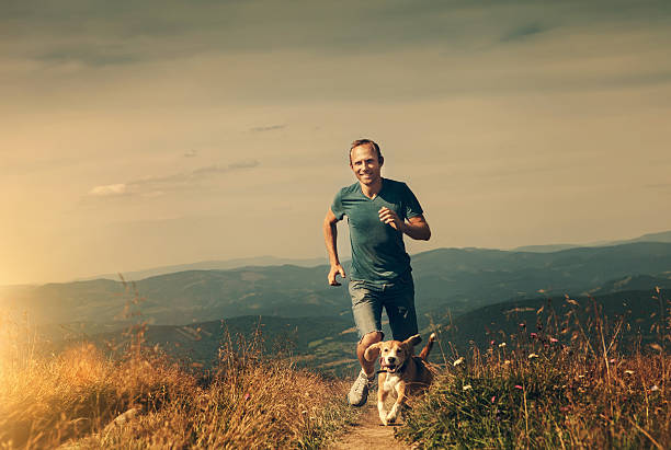 istock Man running with his dog on the mountain tableland 500734288