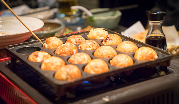 istock Using Chop stick to cook Takoyaki Japanese Octopus Ball 500734418