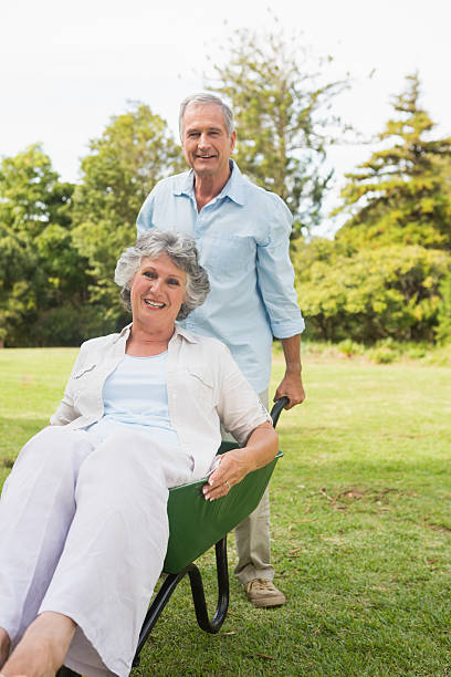 istock Silly man pushing his wife in a wheelbarrow 500735089