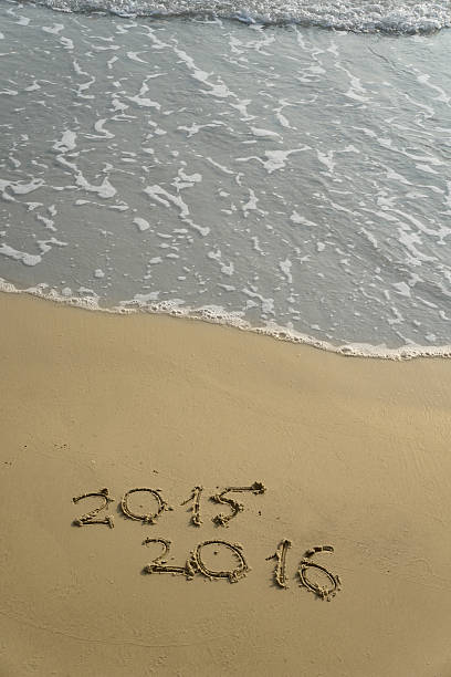 istock 2015 and 2016 year on the sand beach 500735242